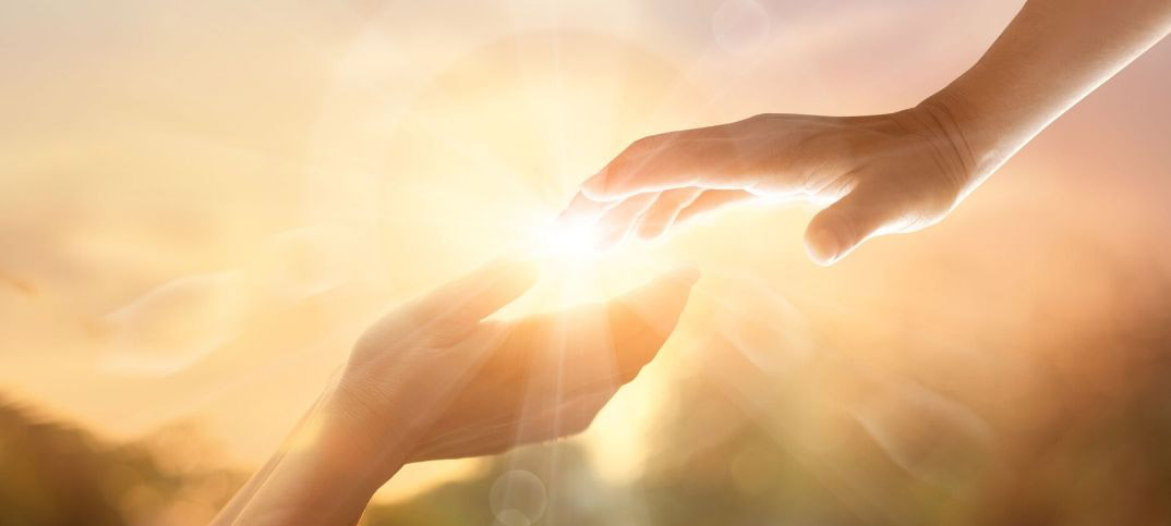  The image shows a hand reaching out from the sky to touch another hand, with a bright light in the background.